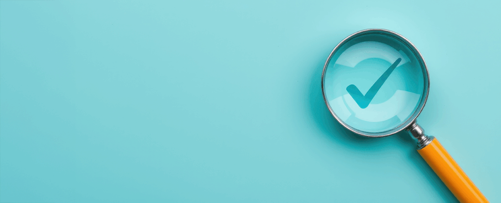 Checkbox under a magnifying glass on a black background